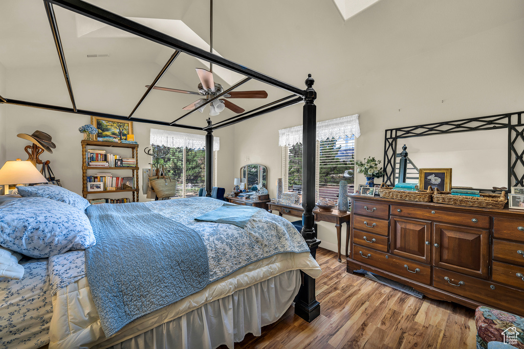 Bedroom featuring wood-type flooring, multiple windows, and ceiling fan