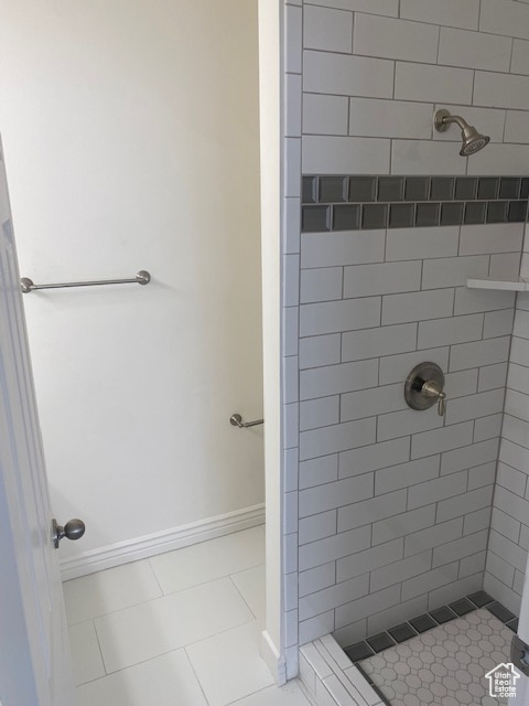 Bathroom featuring a tile shower and tile floors