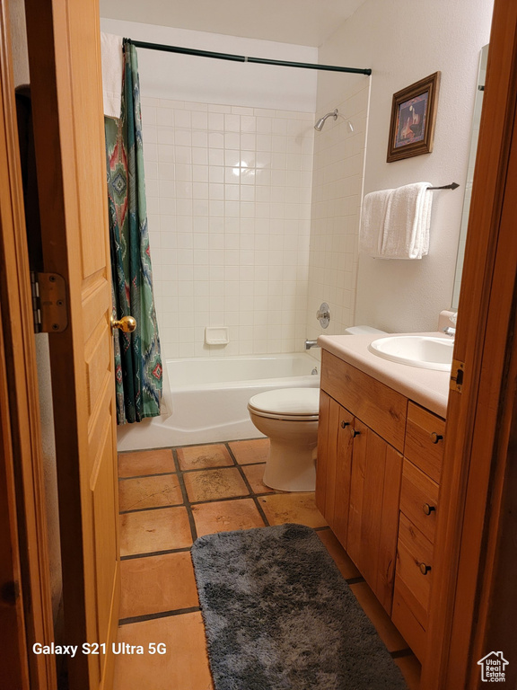 Full bathroom with shower / bath combination with curtain, toilet, vanity, and tile floors