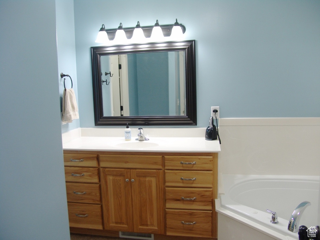 Bathroom with a tub and vanity