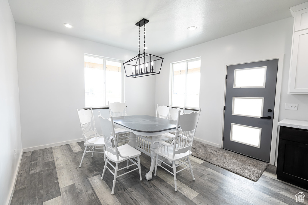 Dining space featuring plenty of natural light, hardwood / wood-style flooring, and a chandelier