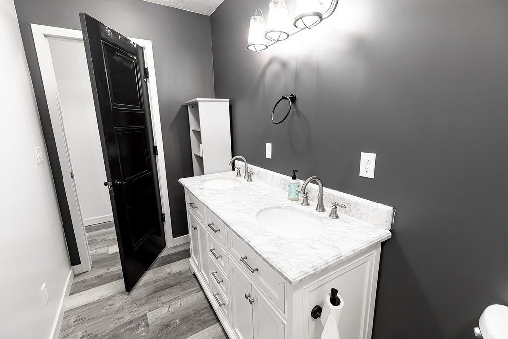 Bathroom featuring double vanity and hardwood / wood-style floors