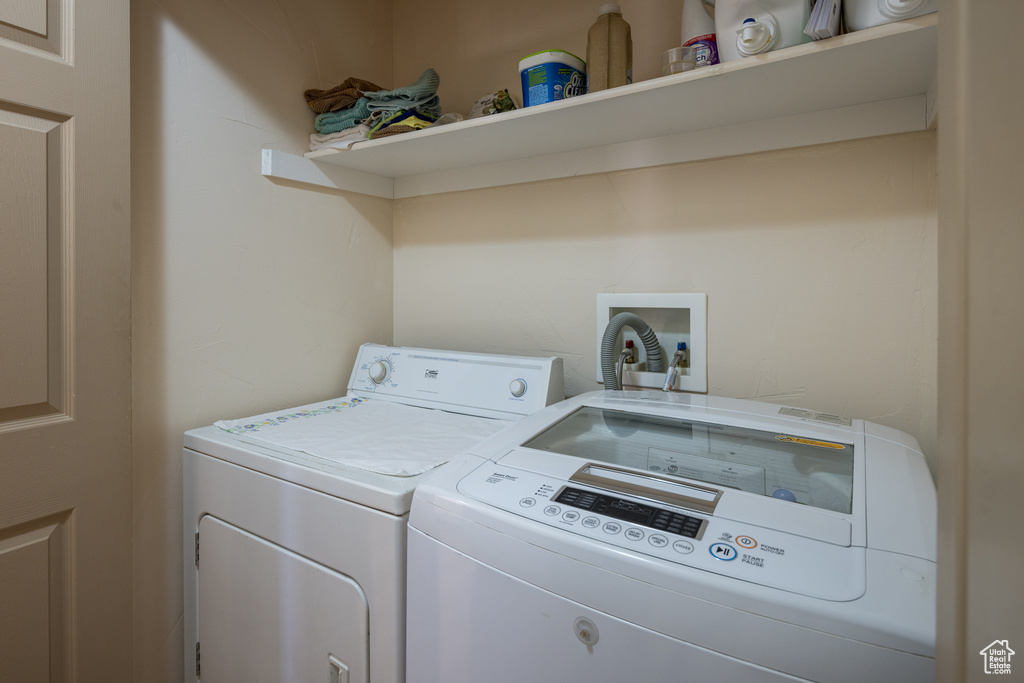 Laundry room with washer hookup and washer and clothes dryer