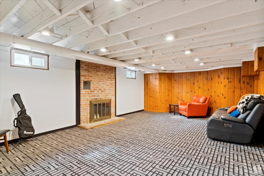 Interior space with brick wall, a fireplace, and wood walls