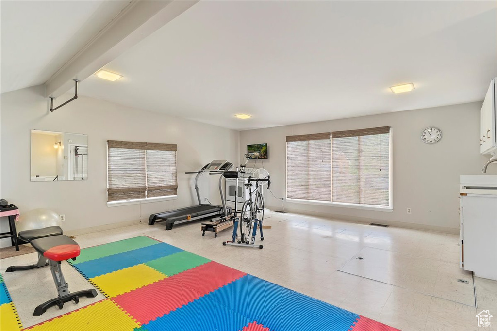 Exercise room with light tile floors