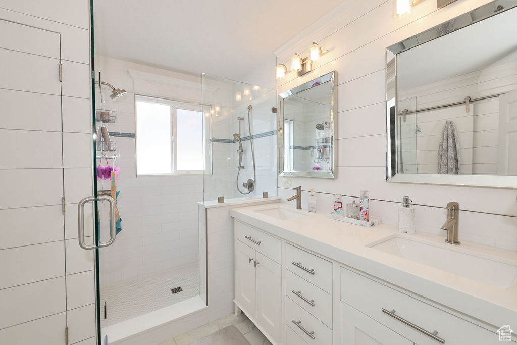 Bathroom with double sink vanity and a shower with shower door