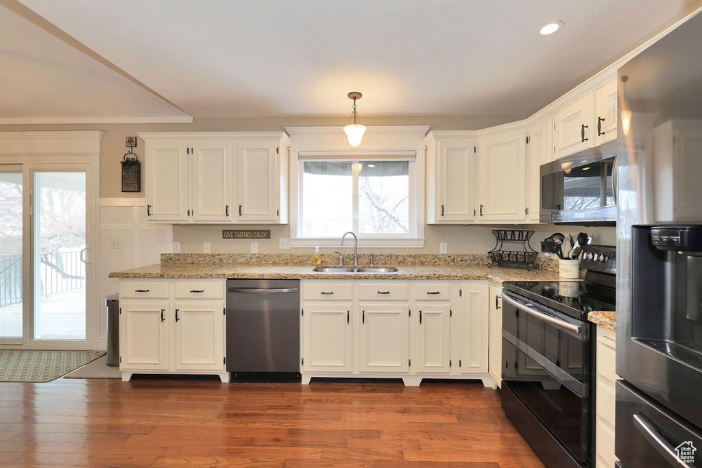 Kitchen featuring sink, dark hardwood / wood-style flooring, stainless steel appliances, and a wealth of natural light