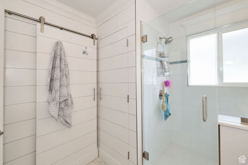 Bathroom featuring an enclosed shower and crown molding