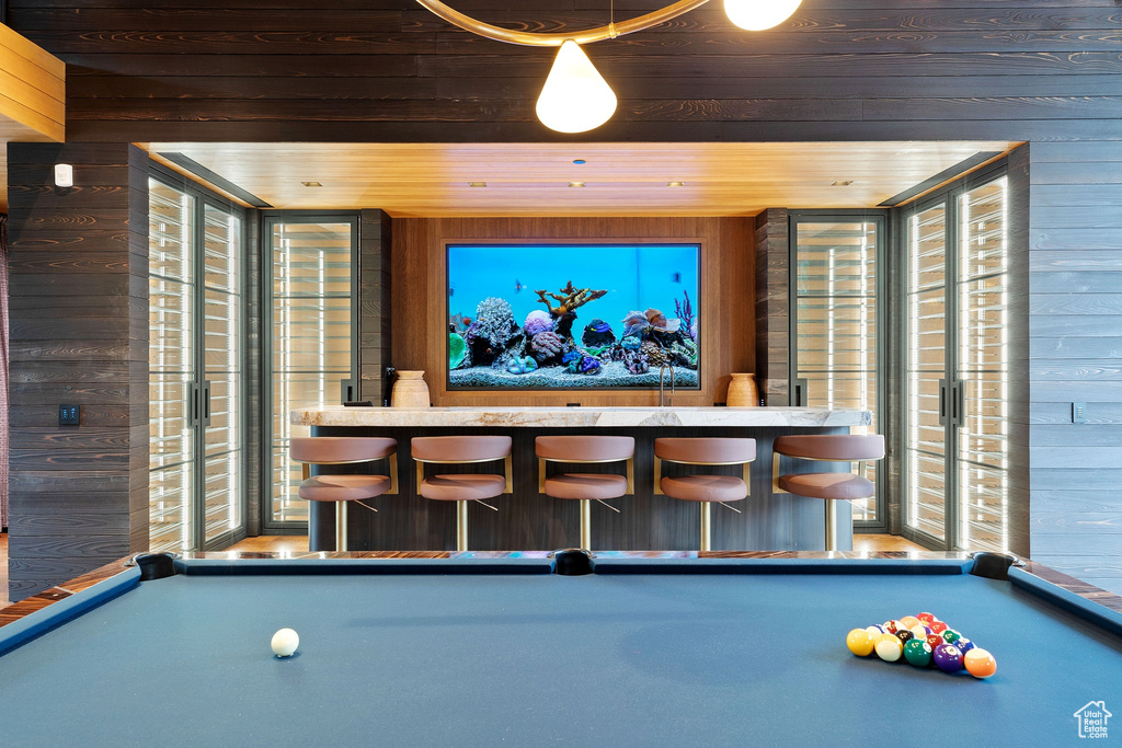 Rec room with wood walls, wood ceiling, and pool table
