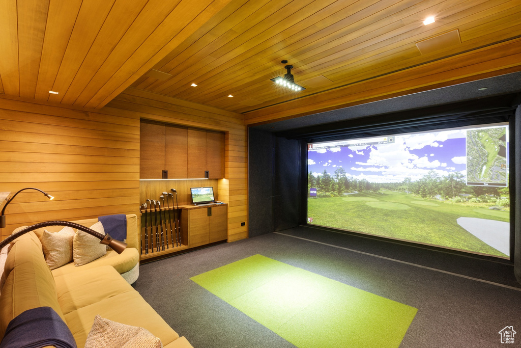 Playroom featuring golf simulator, dark colored carpet, wood walls, and wood ceiling