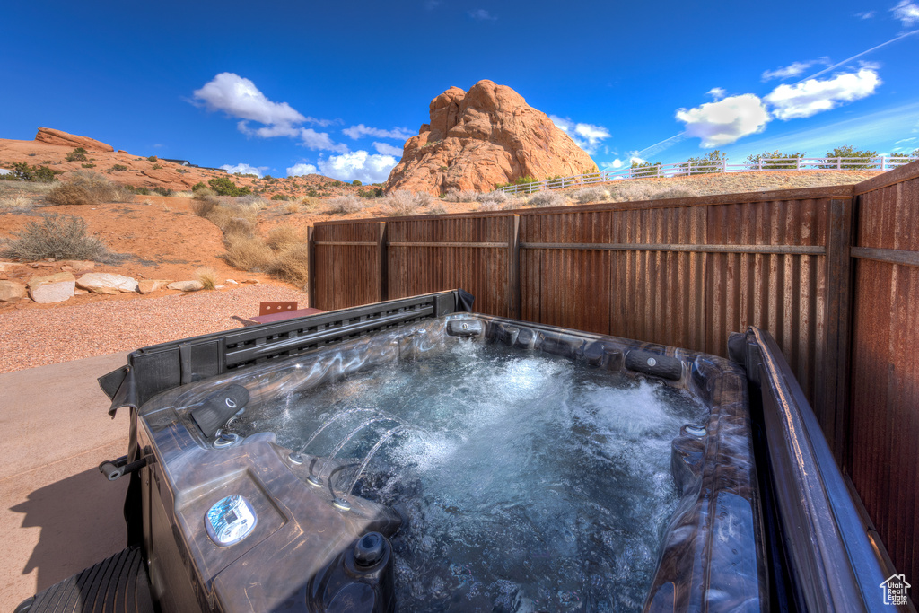View of swimming pool featuring a hot tub and a mountain view