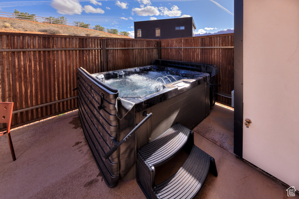 Exterior space with a hot tub