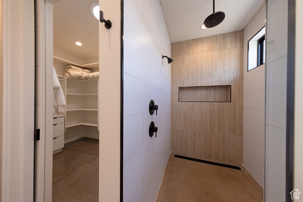 Bathroom featuring walk in shower and concrete flooring
