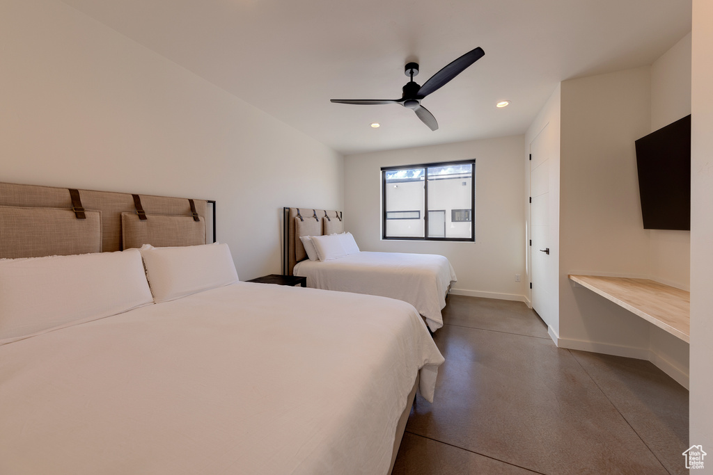 Bedroom with concrete floors and ceiling fan