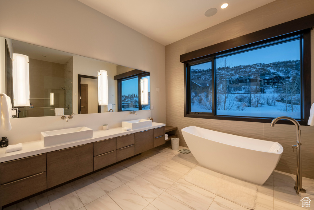 Bathroom with double sink, a mountain view, tile floors, oversized vanity, and a bathing tub