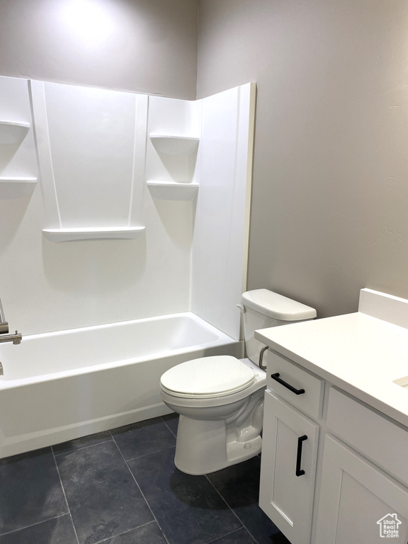 Full bathroom with shower / bath combination, tile floors, toilet, and vanity