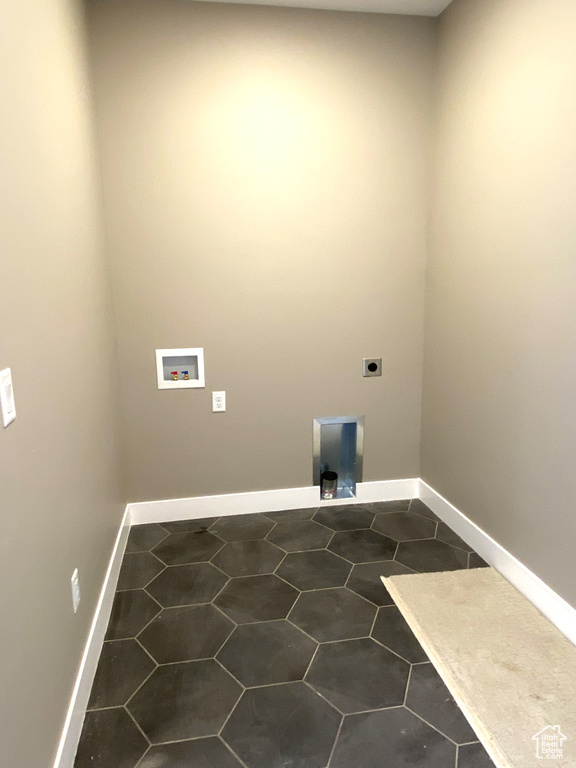 Clothes washing area with hookup for an electric dryer, tile floors, and washer hookup