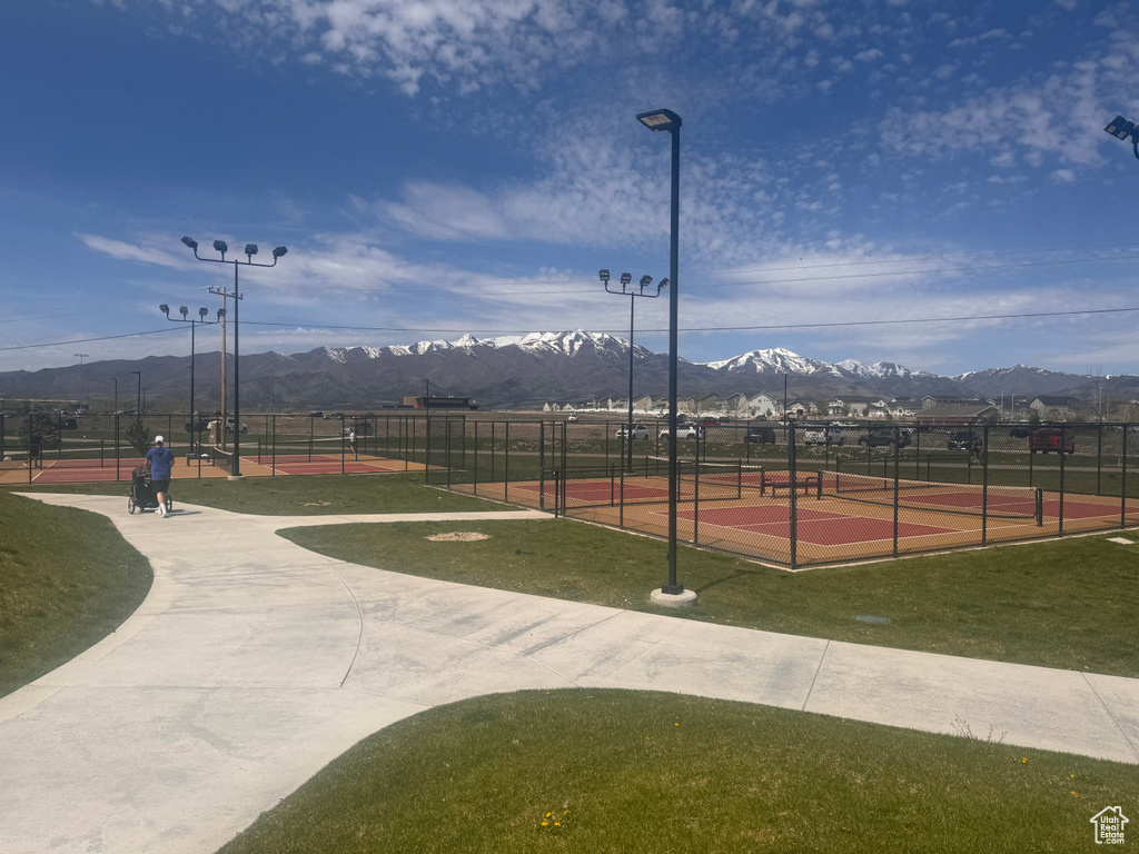 View of property\'s community with tennis court, a mountain view, and a yard