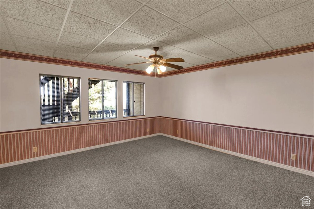 Spare room featuring carpet flooring, a paneled ceiling, and ceiling fan