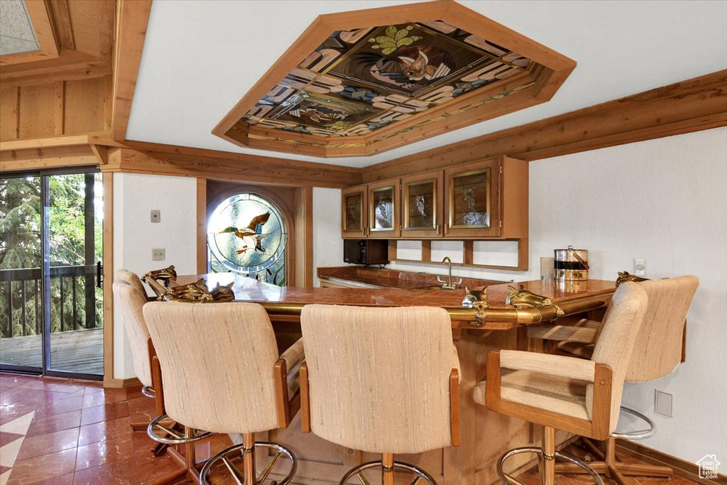 Tiled dining room with a tray ceiling