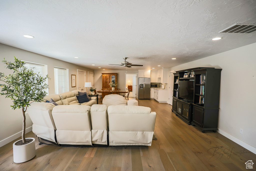 Living room featuring dark hardwood / wood-style floors and ceiling fan