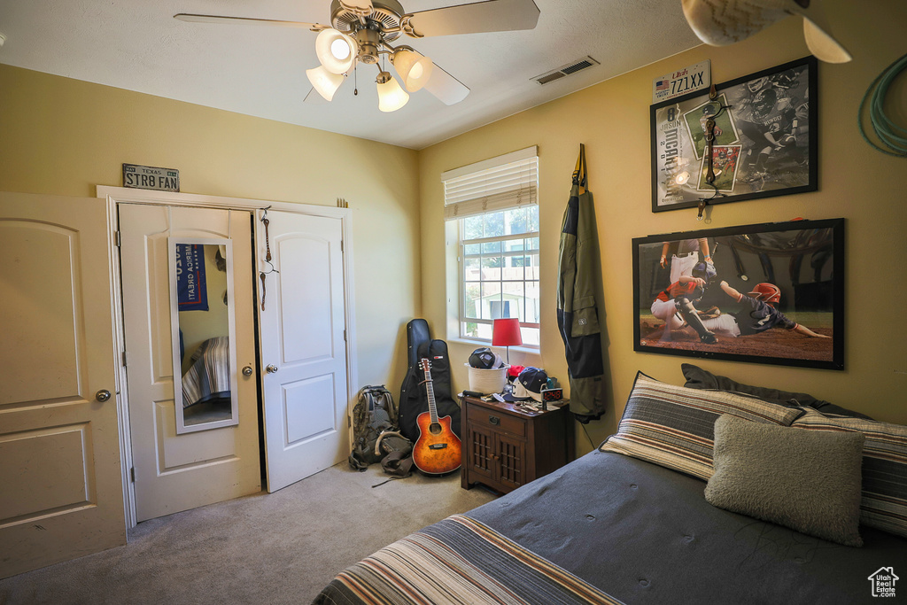 Bedroom featuring a closet, carpet flooring, and ceiling fan