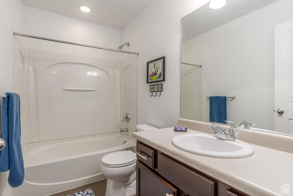 Full bathroom featuring vanity, toilet, and washtub / shower combination