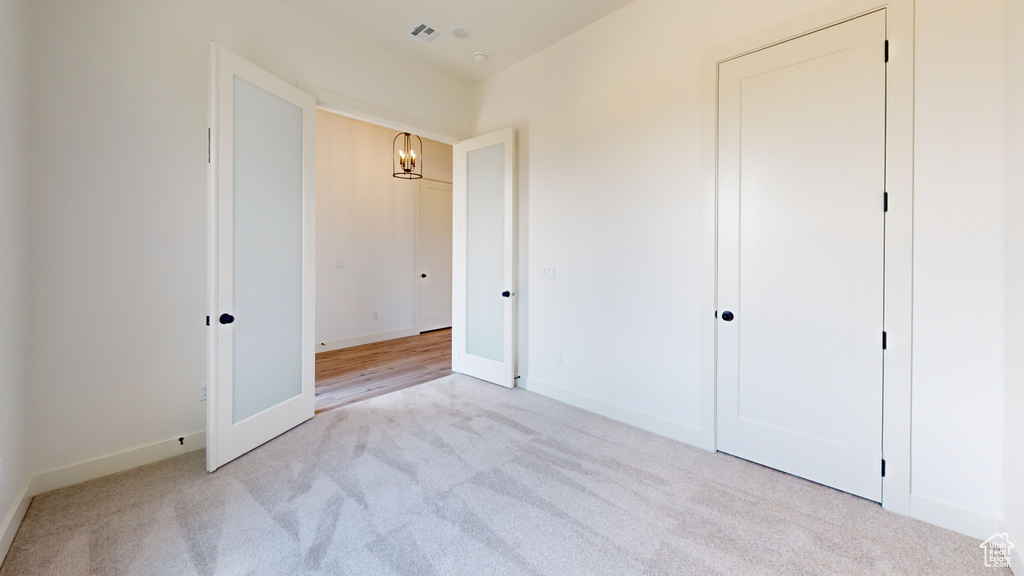 Unfurnished bedroom with light hardwood / wood-style floors and a closet