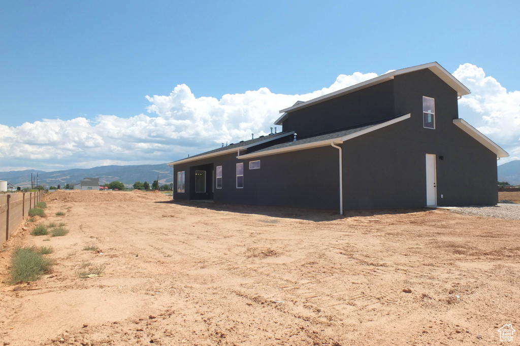 View of property exterior featuring a mountain view