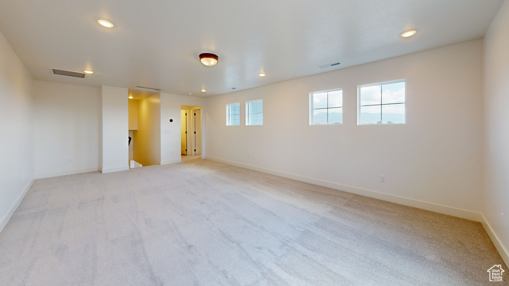 Empty room featuring light colored carpet