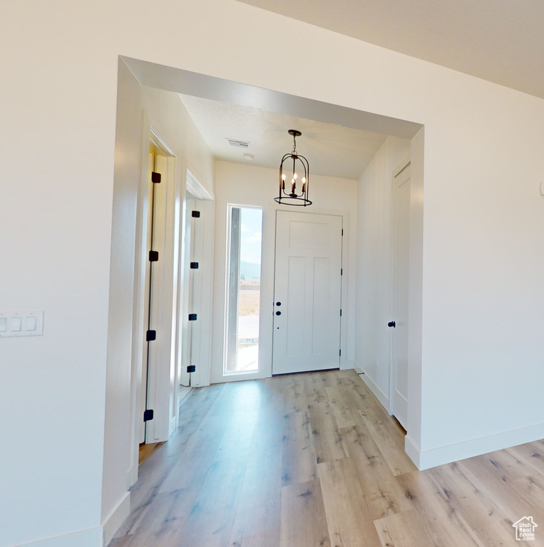 Entryway featuring a notable chandelier and light hardwood / wood-style floors