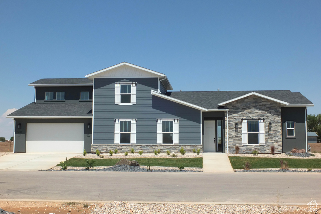 View of front facade featuring a garage