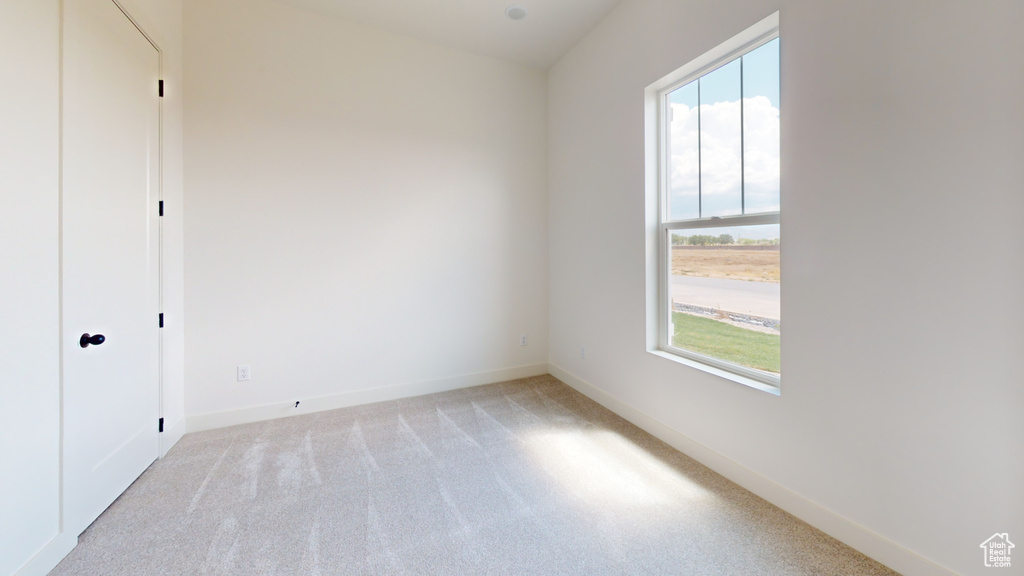 Empty room with light colored carpet