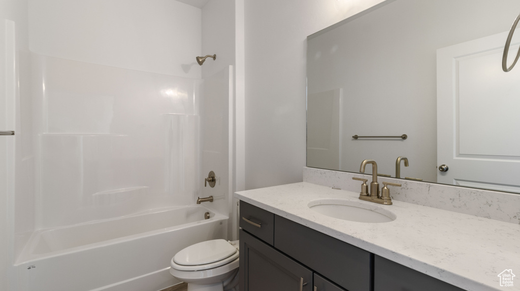 Full bathroom with shower / bath combination, large vanity, and toilet