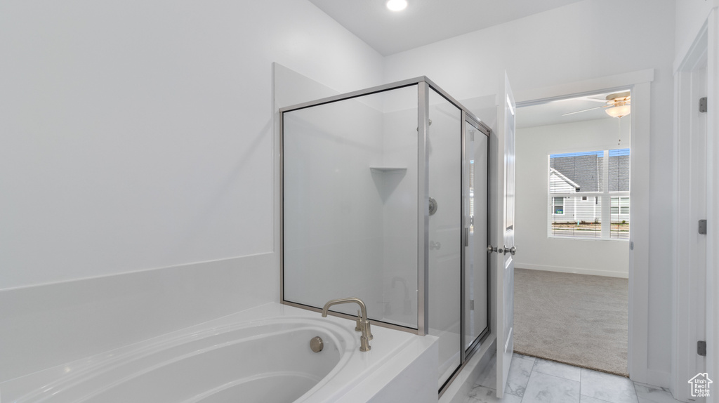 Bathroom featuring a washtub, tile floors, and ceiling fan