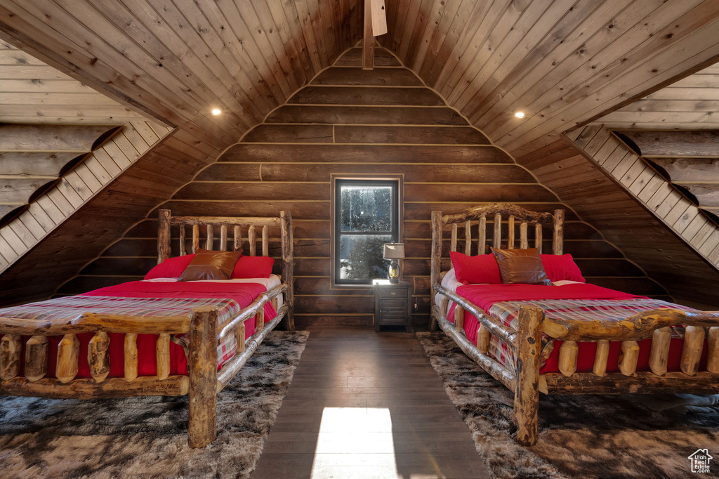 Bedroom featuring dark hardwood / wood-style flooring, lofted ceiling, log walls, and wooden ceiling