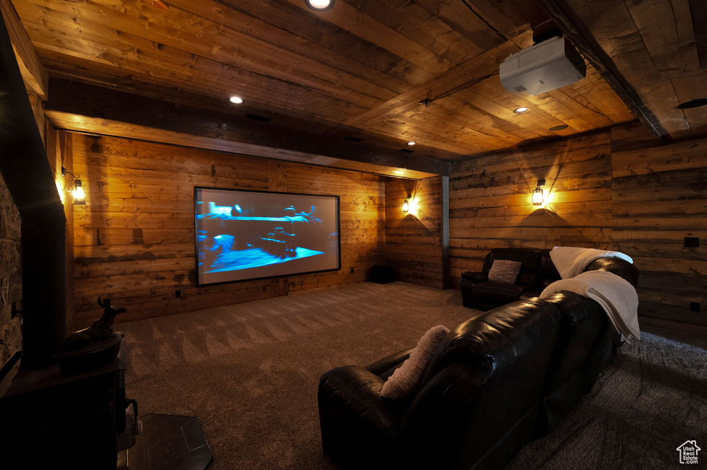 Carpeted cinema with log walls and wooden ceiling
