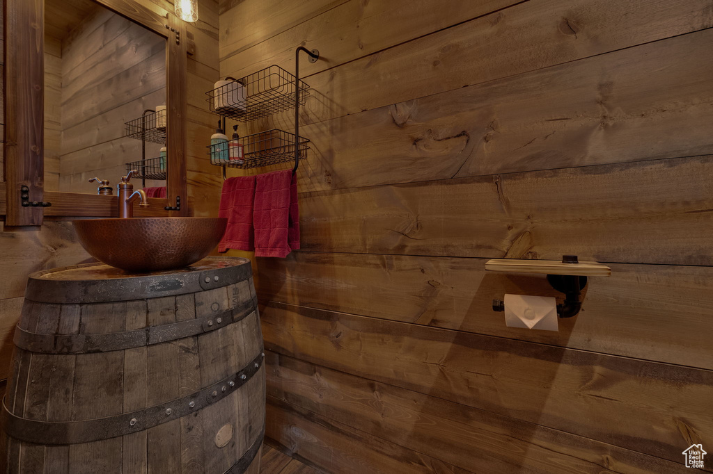 Bathroom featuring wooden walls and sink