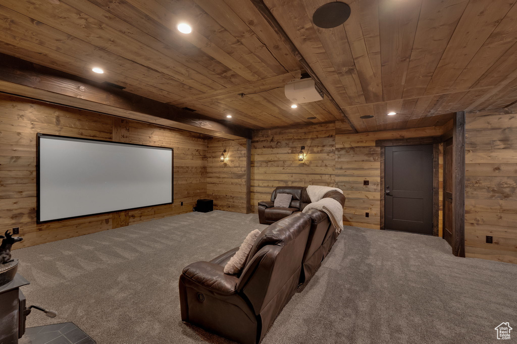 Carpeted cinema room with wooden walls and wooden ceiling
