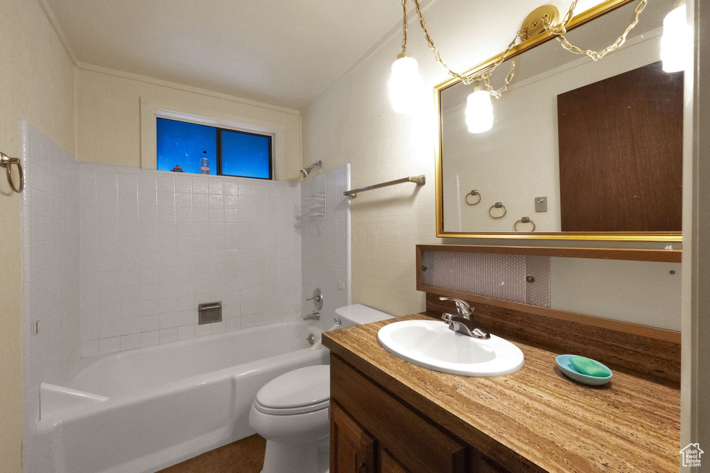 Full bathroom with washtub / shower combination, toilet, and vanity