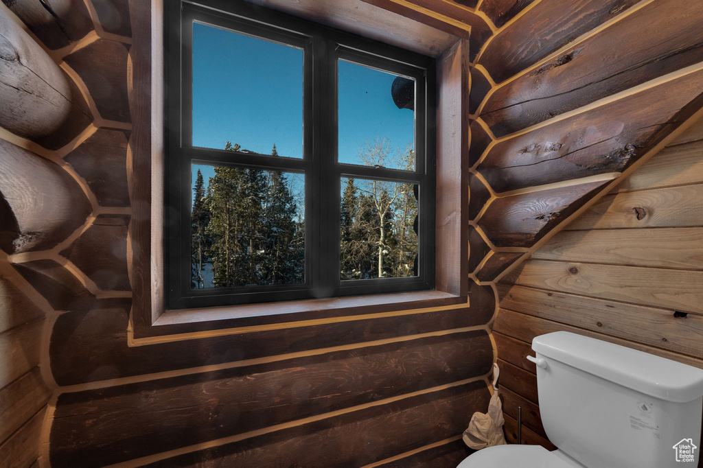Bathroom with wooden walls and toilet
