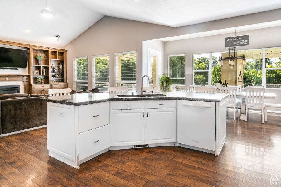 Kitchen with white cabinetry, dishwasher, pendant lighting, and sink