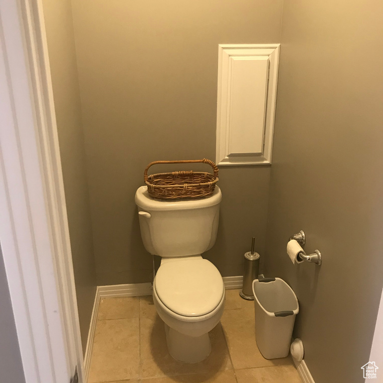 Bathroom with toilet and tile floors