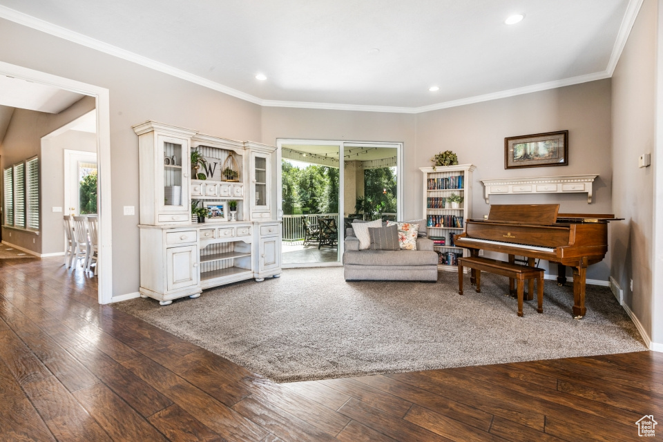 Interior space with dark wood-type flooring and crown molding