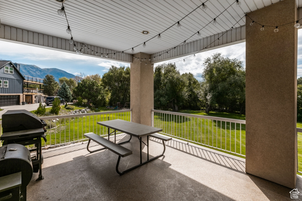 View of patio / terrace with a mountain view, a grill, and a balcony