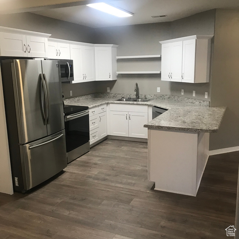 Kitchen featuring white cabinets, stainless steel appliances, and sink