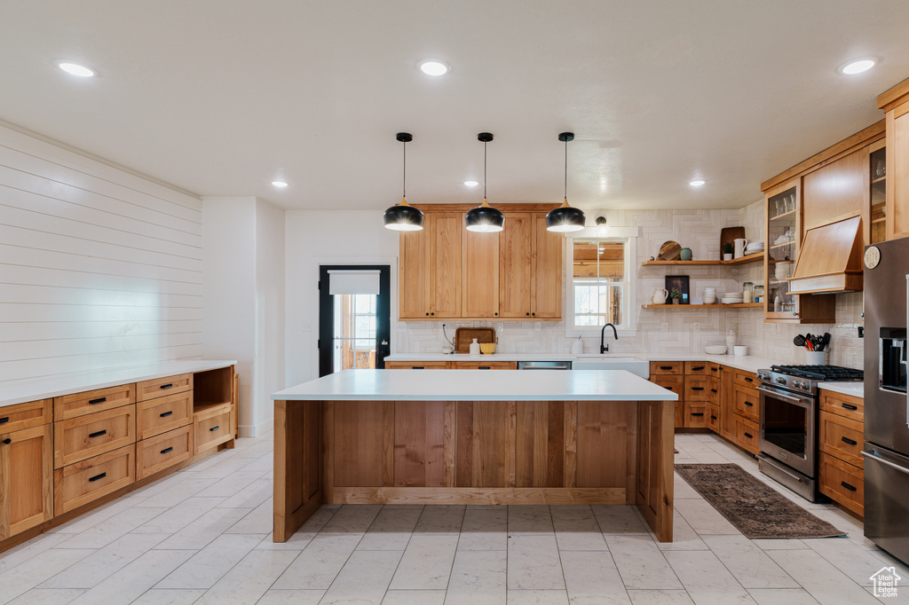 Kitchen with a center island, stainless steel appliances, and plenty of natural light