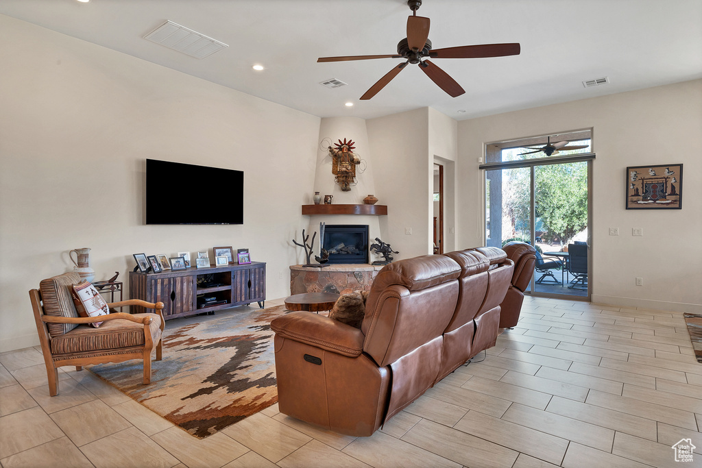 Living room featuring light tile floors and ceiling fan