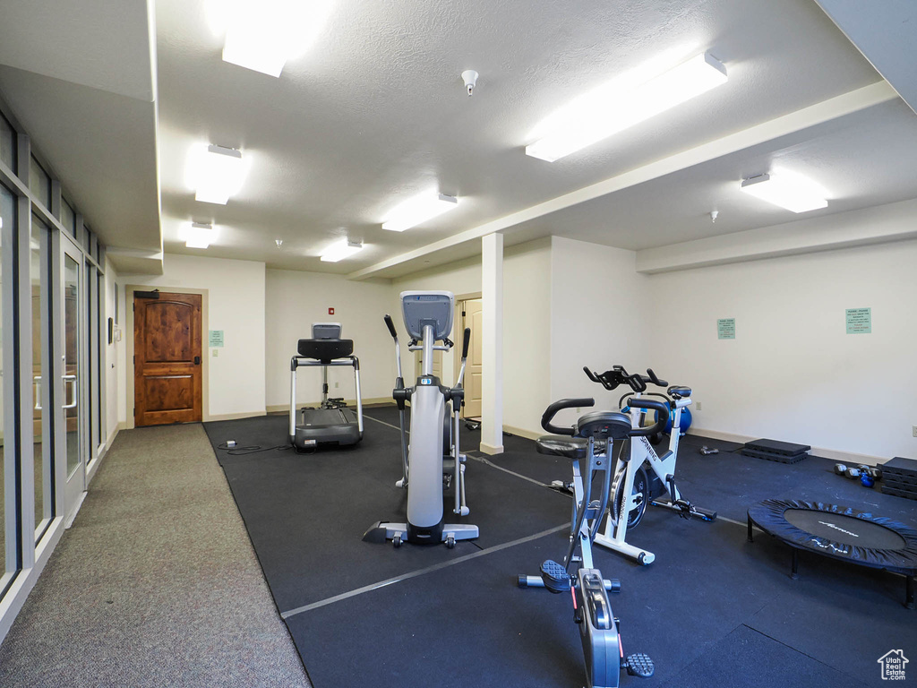 Exercise area featuring a textured ceiling