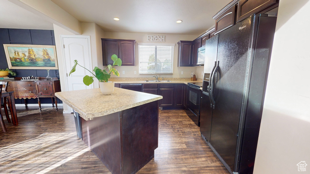 Kitchen featuring black appliances, dark brown cabinetry, and dark hardwood / wood-style floors